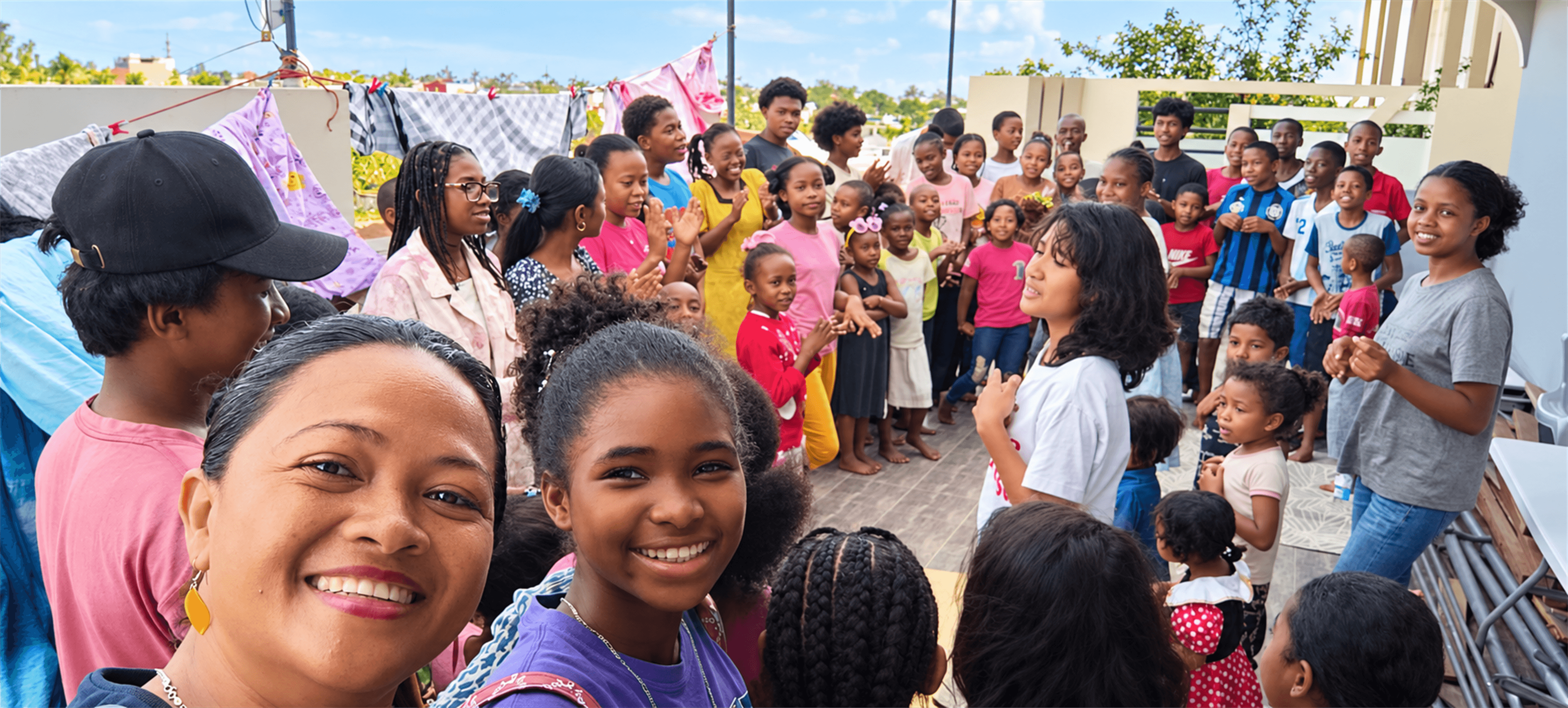 AMI team members and children gathered together at a community event in Madagascar